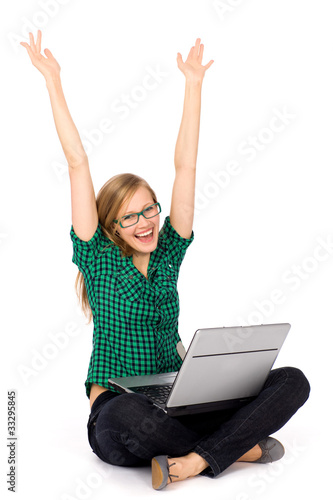 Girl with laptop raising her arms in joy © pikselstock