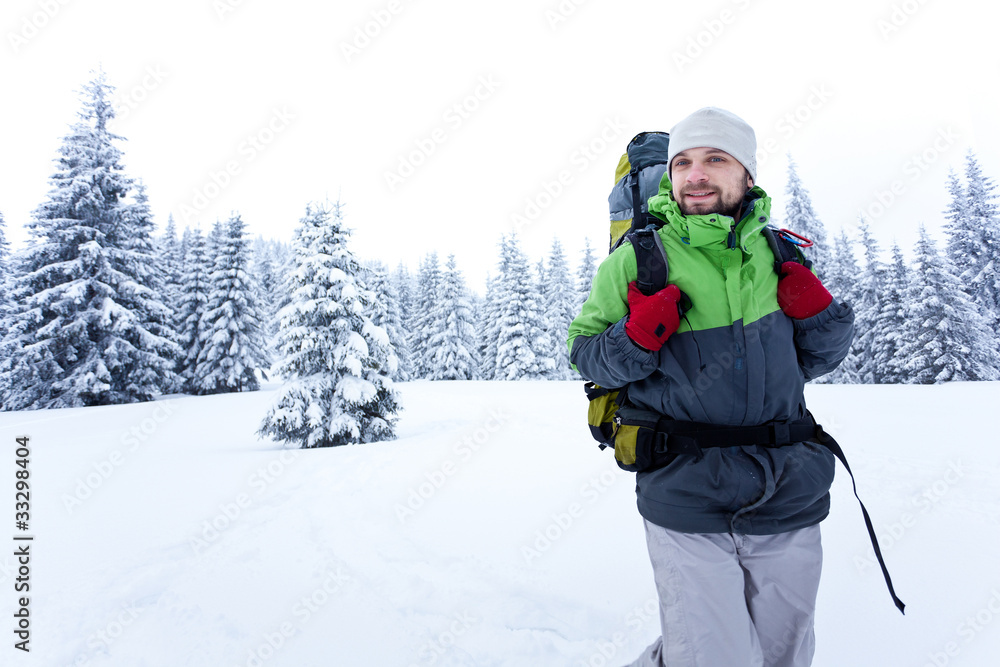 Hiker walks in snow forest