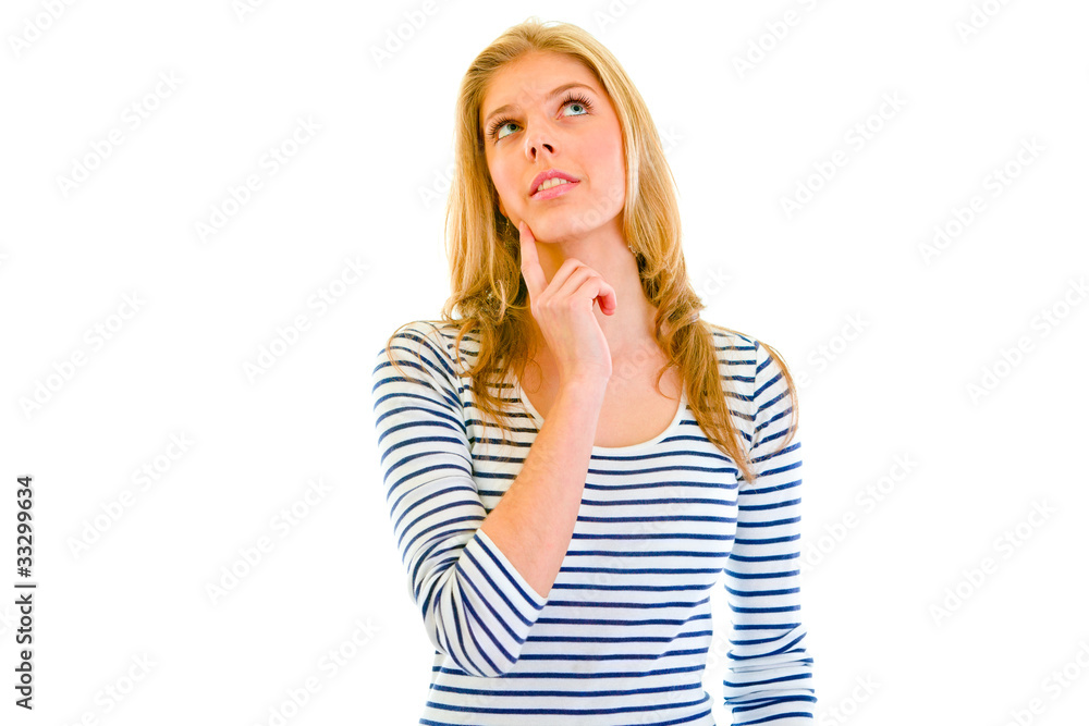 Thoughtful girl with hand near face looking up at copy-space Thoughtful girl with hand near face looking up at copy-space