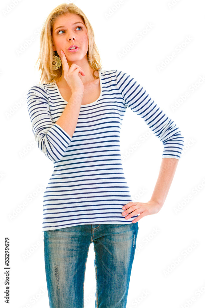 Pensive teen girl with hand near face looking up at copy-space Pensive teen girl with hand near face looking up at copy-space