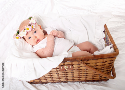 Portrait of a baby girl with a wreath of flowers