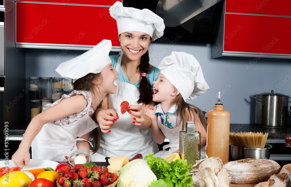mother and two daughters in the kitchen mother and two daughters in the kitchen