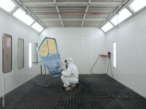 painter works in a spray booth photo