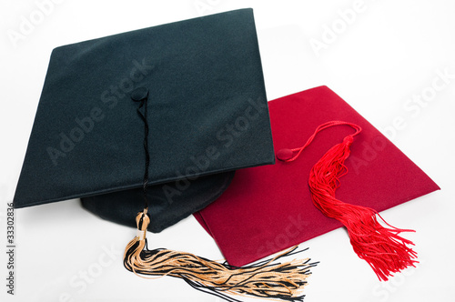 Black and red graduation caps with tassels.