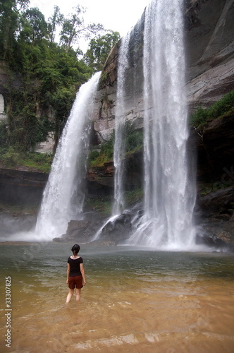A girl facing giant waterfall