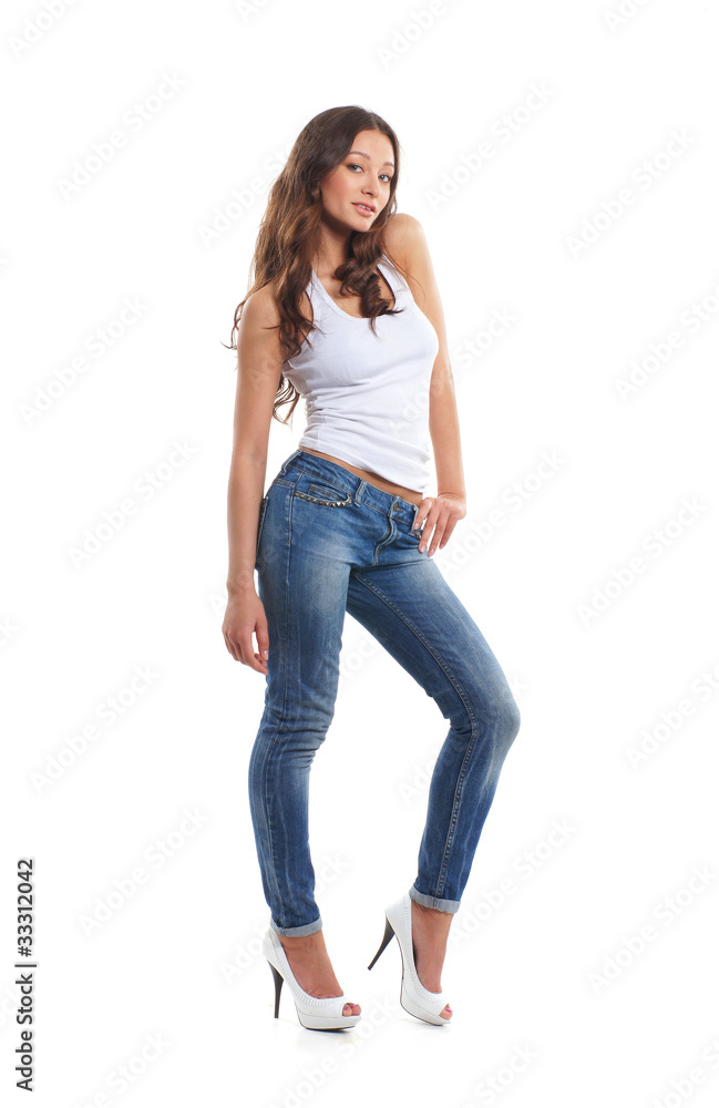 A young and sexy brunette Caucasian woman in stylish jeans A young and sexy brunette Caucasian woman in stylish jeans
