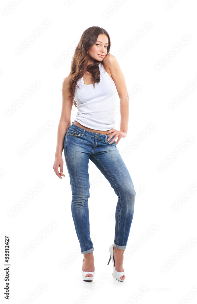 A young and sexy brunette Caucasian woman in stylish jeans A young and sexy brunette Caucasian woman in stylish jeans