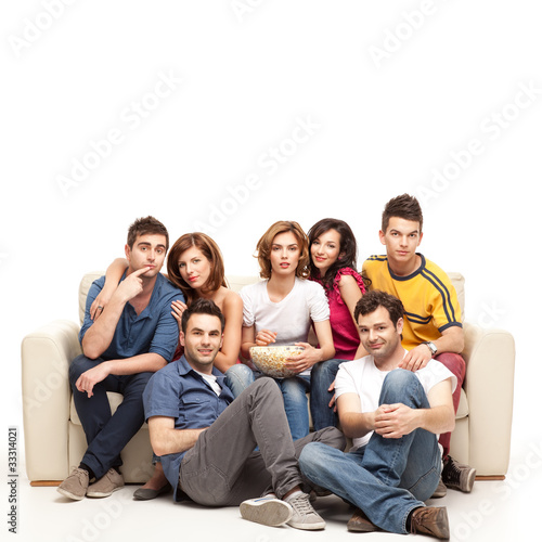 young casual friends watching television