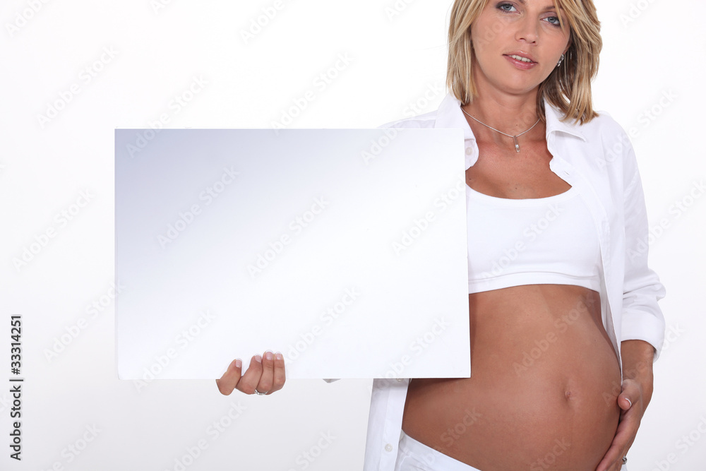 Pregnant blond model holding message board Pregnant blond model holding message board