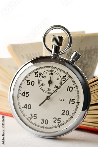 Stopwatch and book on the white background