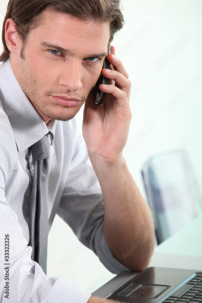Young businessman on telephone Young businessman on telephone