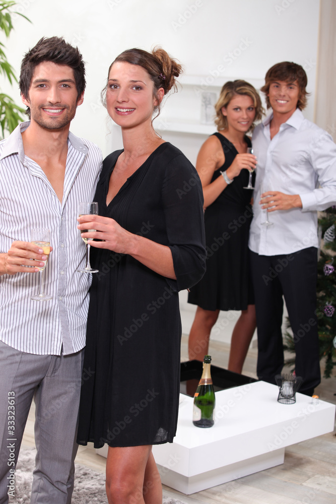 Young people drinking champagne at Christmas Young people drinking champagne at Christmas