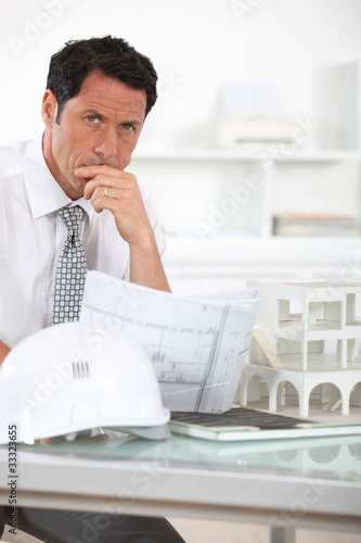 Architect with plans and 3D model