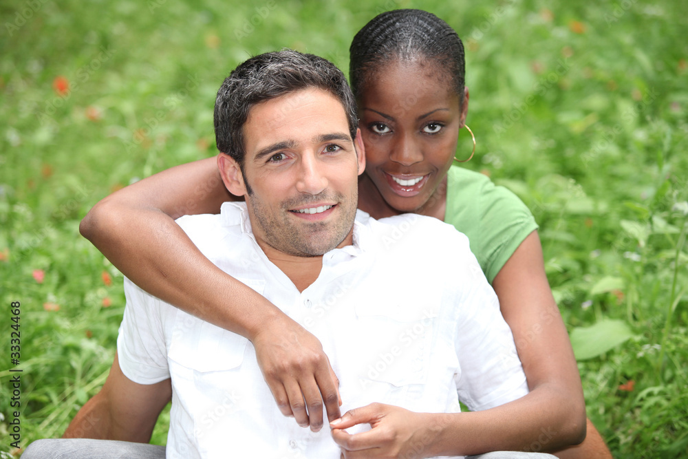 Couple sit in the grass Couple sit in the grass