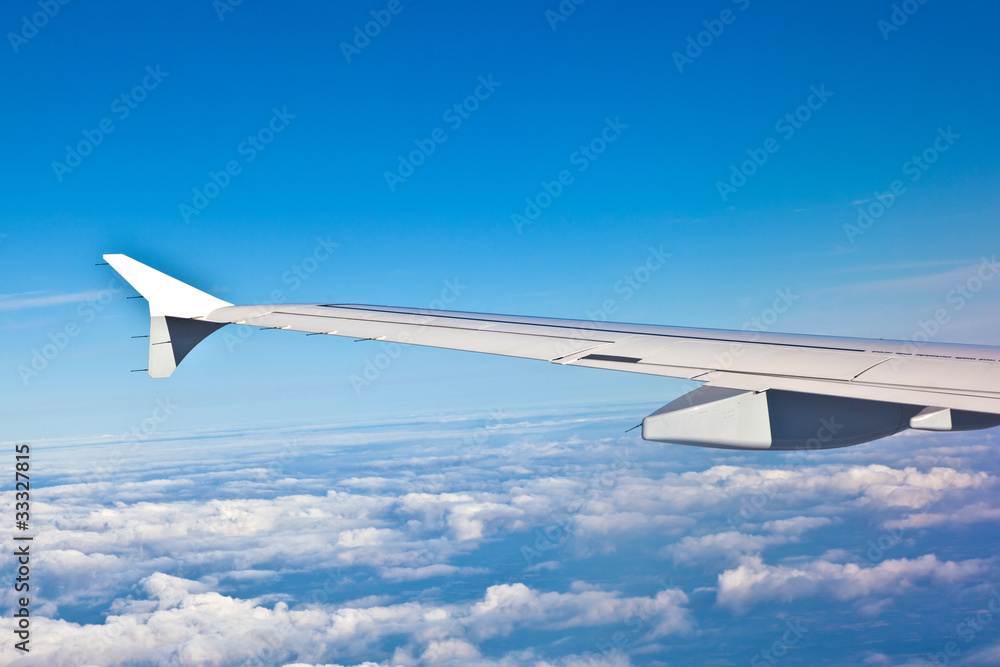 Wing of aircraft in the blue sky Wing of aircraft in the blue sky