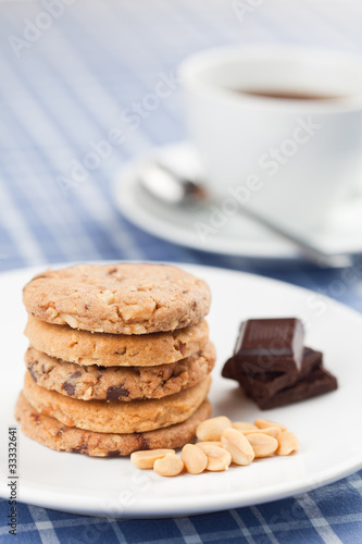 Peanut cookies with chocolate and cup of coffee or tea.