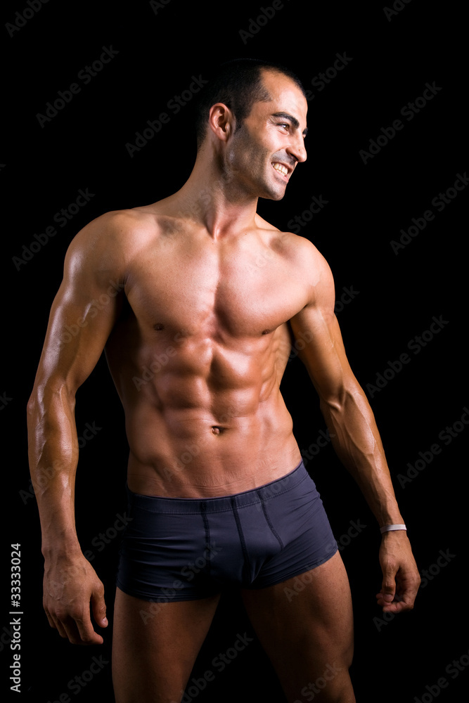 Sexy muscular man against black background