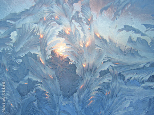 frost and sun on winter glass photo