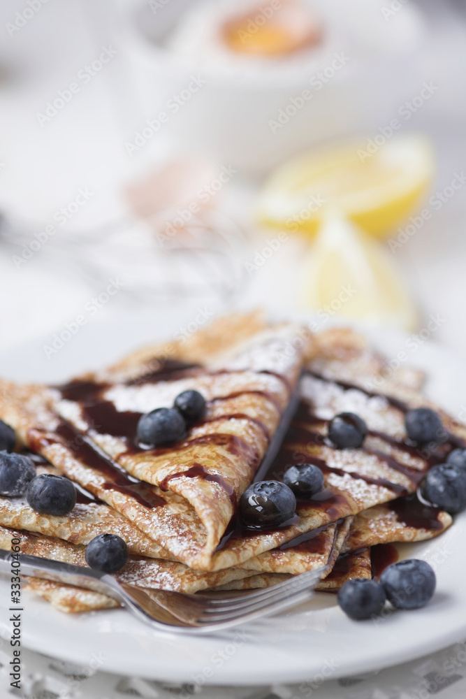 Freshly prepared crepes with blueberries & chocolate sauce