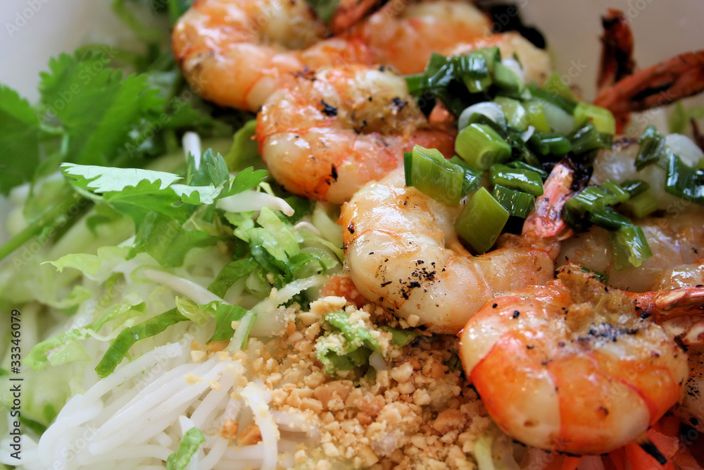 Grilled shrimp on bed of rice noodles and greens. Grilled shrimp on bed of rice noodles and greens.