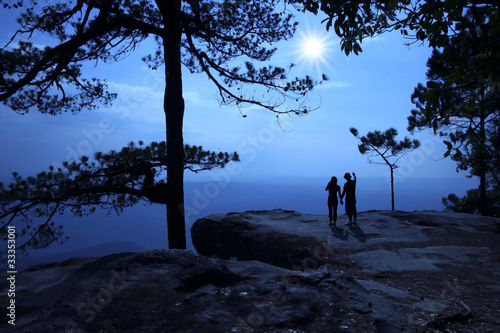 Silhouette of couple on tourists. When sunrise