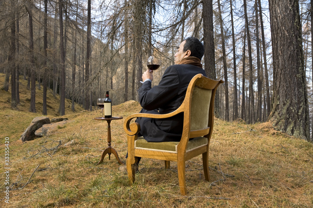 man sitting on the chair drinking wine man sitting on the chair drinking wine
