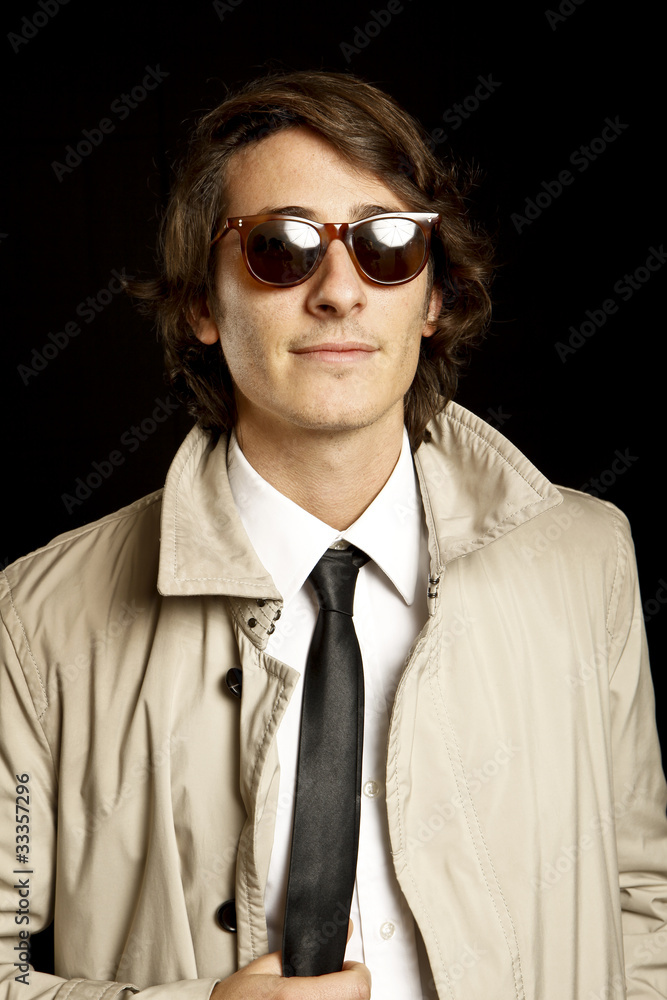 fashion young man with sunglasses and trench coat