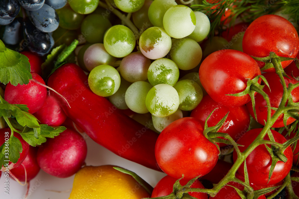 Photo of a table top full of fresh vegetables, fruit, and other