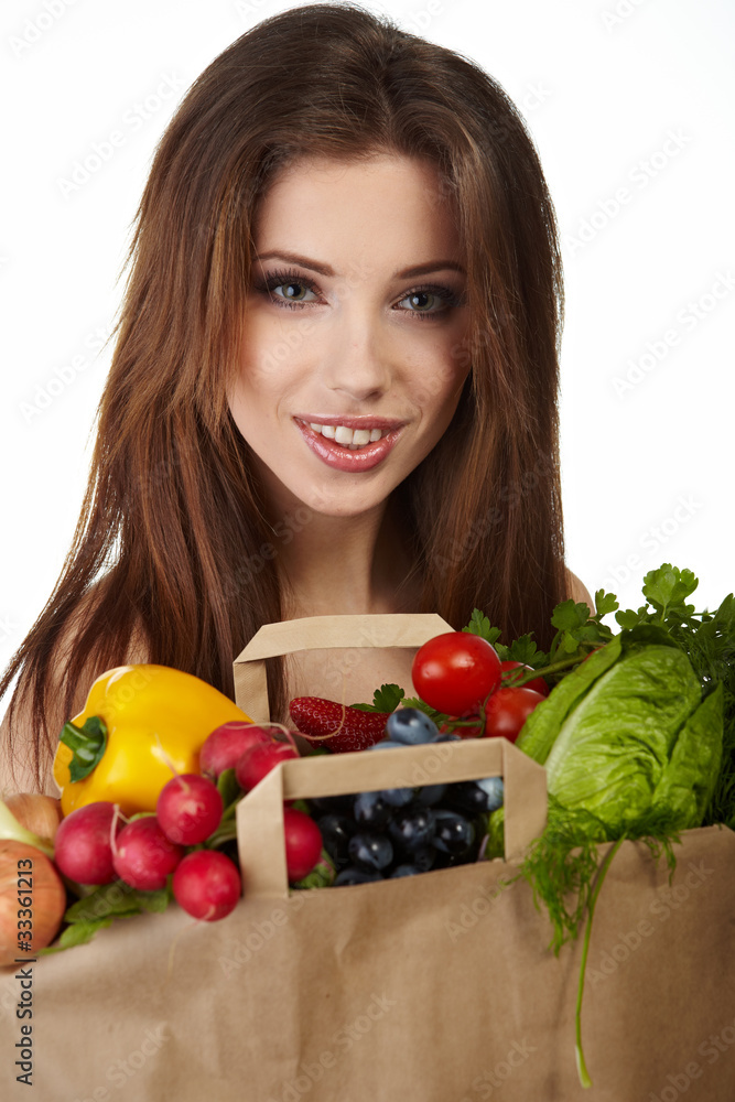 Portrait of happy woman holding a shopping bag full of groceries Portrait of happy woman holding a shopping bag full of groceries