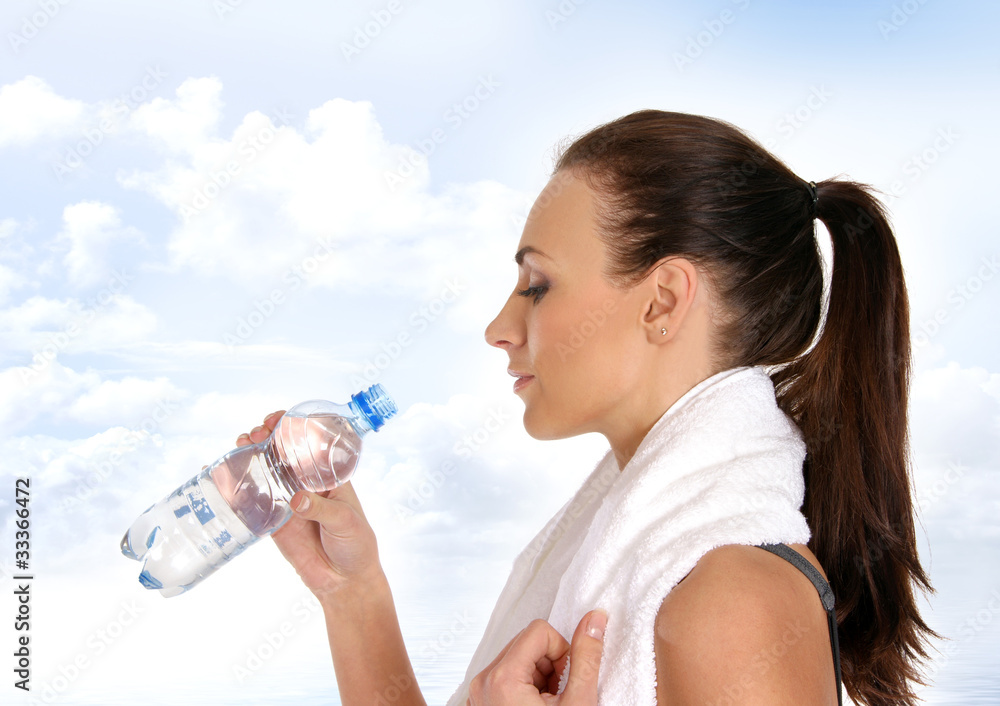 A young and fit brunette woman drinking fresh water A young and fit brunette woman drinking fresh water
