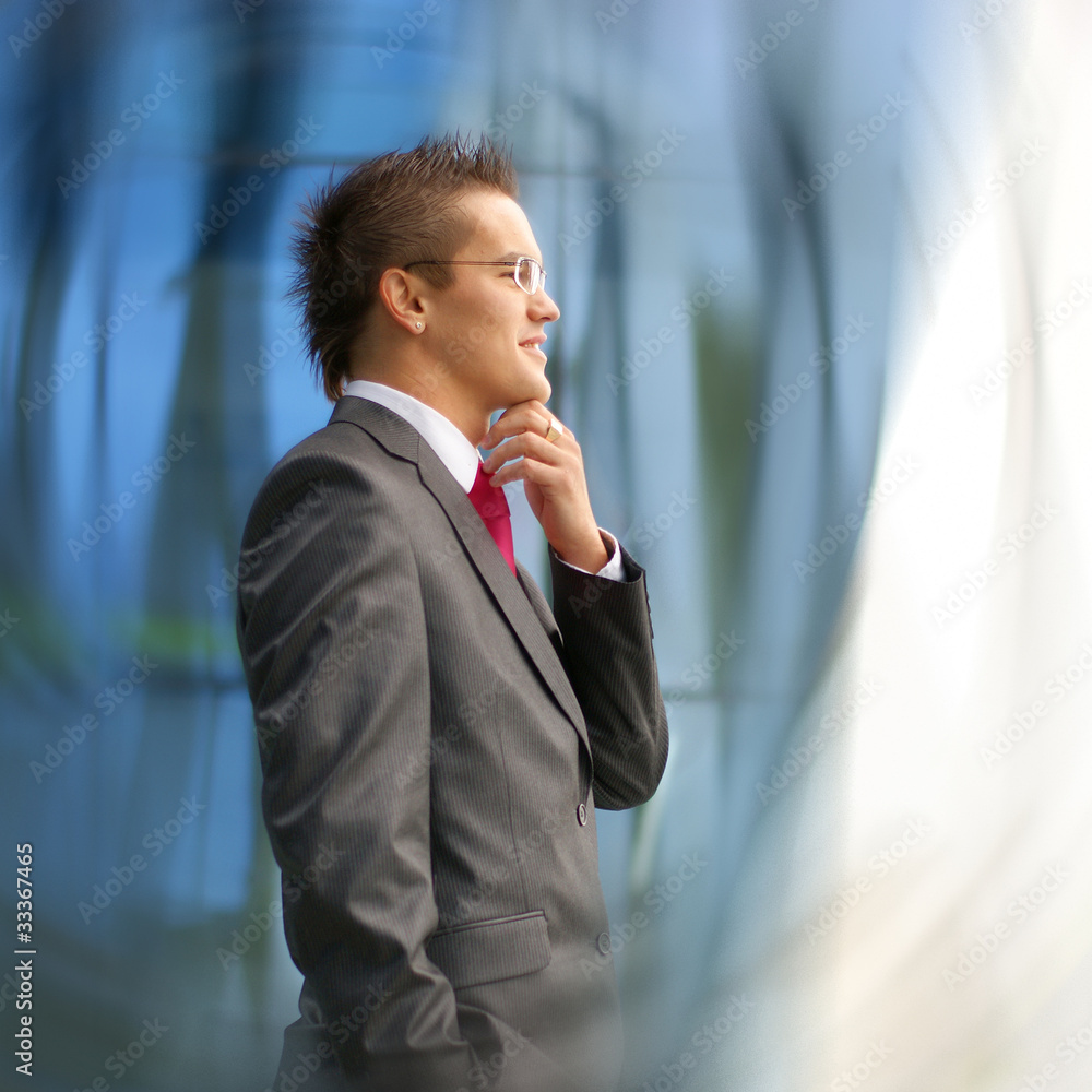 A young brunette Caucasian businessman in formal clothes A young brunette Caucasian businessman in formal clothes