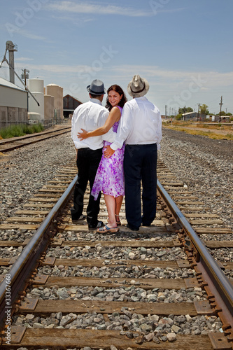 Woman with men representing a romantic triangle or polyamory photo