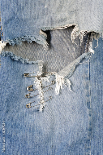 Torn Blue Jeans Patched with Safety Pins