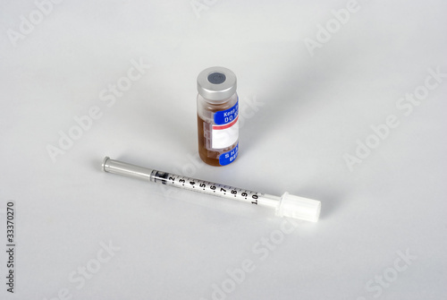 Syringe and serum on a white background