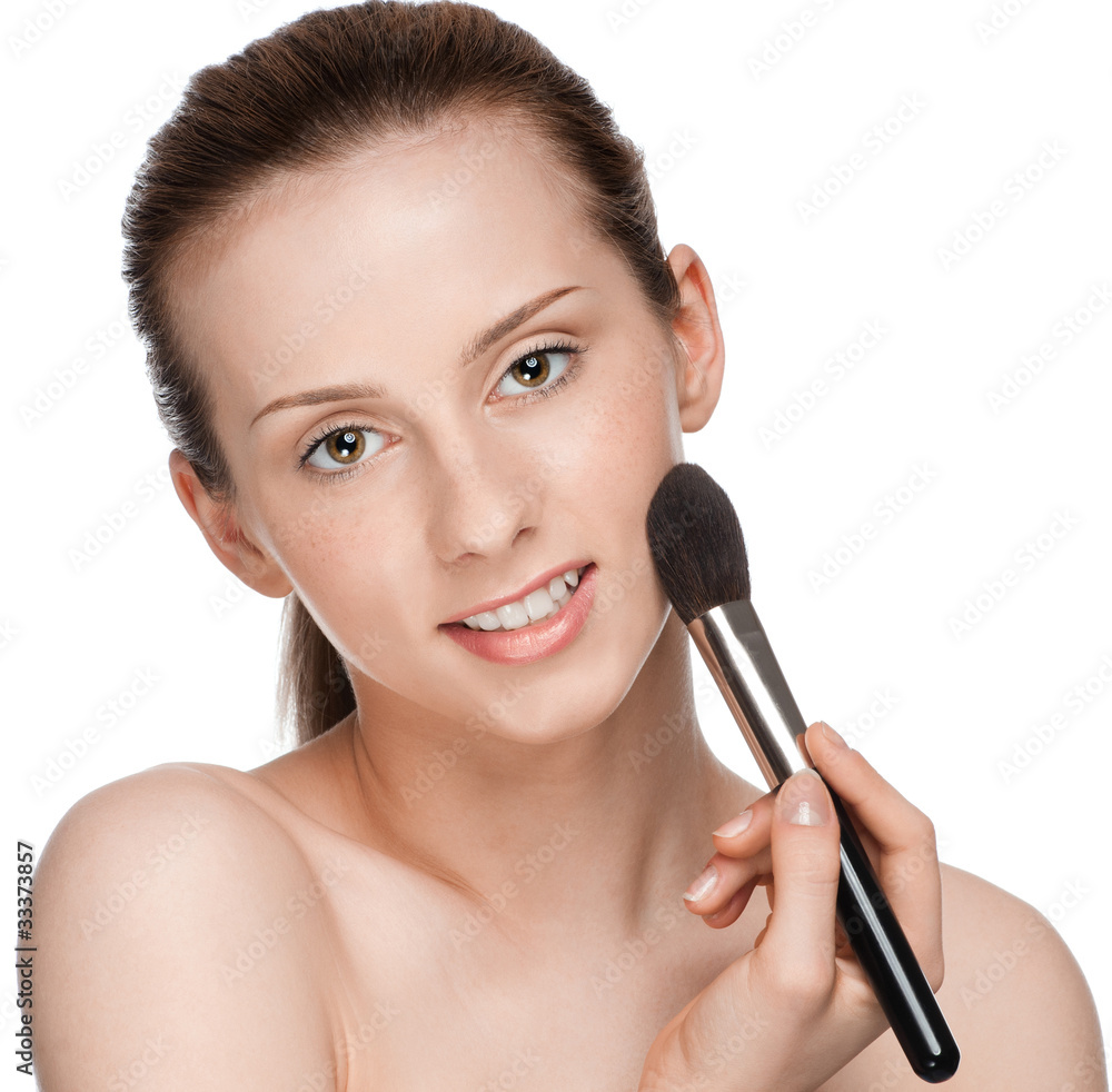 Beautiful young adult woman applying cosmetic brush Beautiful young adult woman applying cosmetic brush