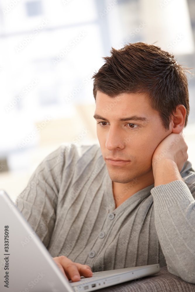 Goodlooking guy using laptop Goodlooking guy using laptop