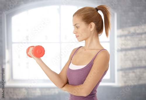 Sporty woman with dumbbell