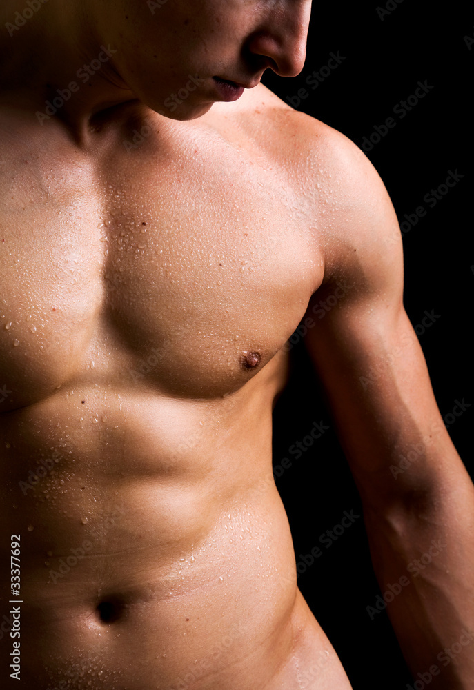 Young man with naked torso on black background Young man with naked torso on black background