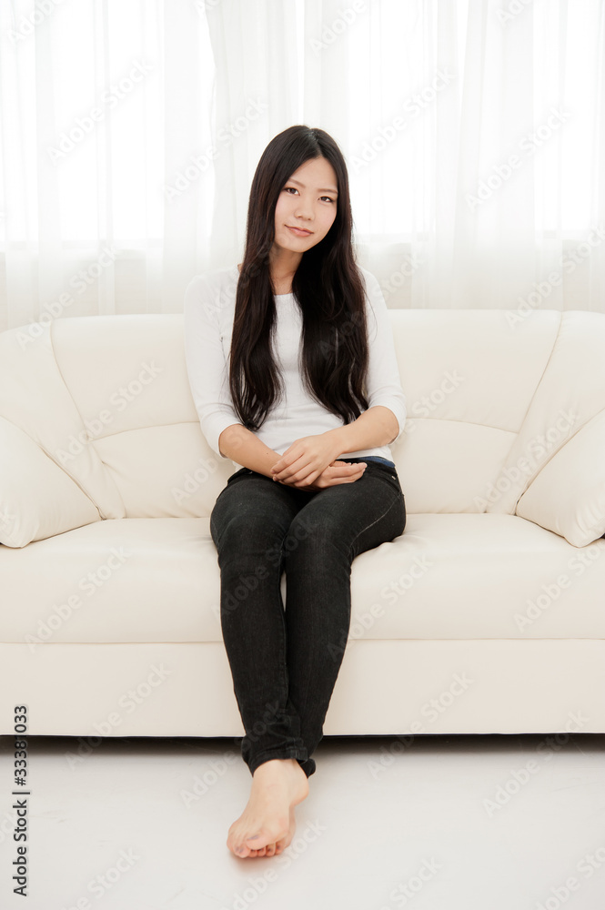 beautiful asian woman relaxing on the couch Stock Photo