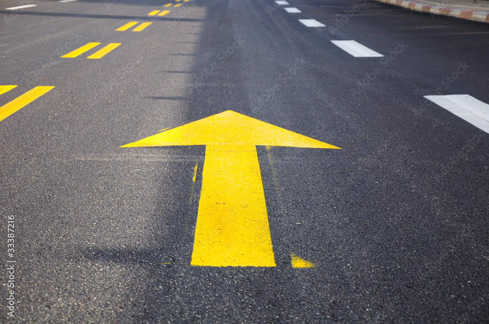 Yellow arrow showing the road traffic direction. Yellow arrow showing the road traffic direction.