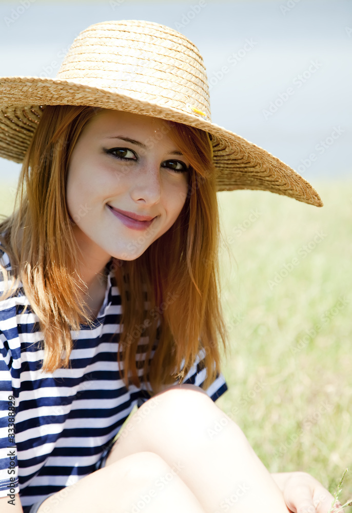 Beautiful redhead girl at countryside nead lake.