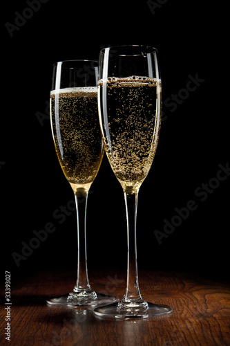 two glass with champagne on a wooden table