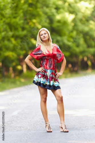 Quadro su tela Young blond woman outdoor on a street