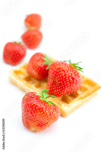 Waffles and strawberries isolated on white