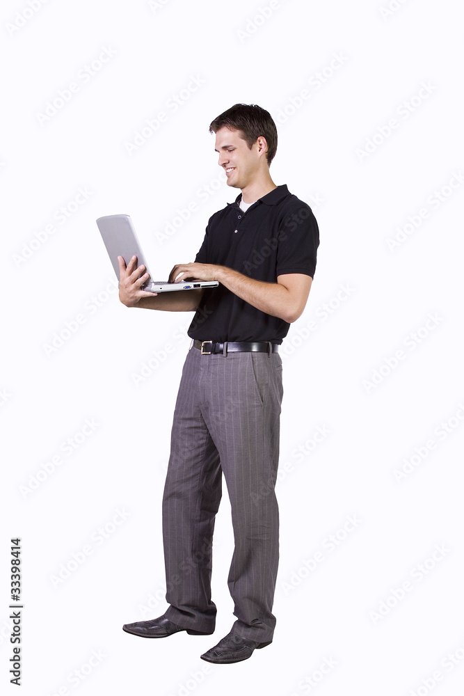 Young man standing and working  on laptop
