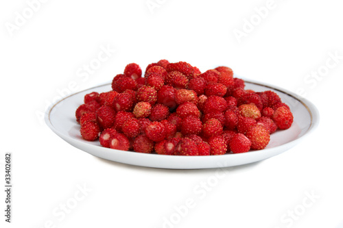 plate full of wild strawberries isolated on white