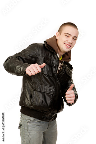 Portrait of a young boy laughing and gives a thumbs up sign.