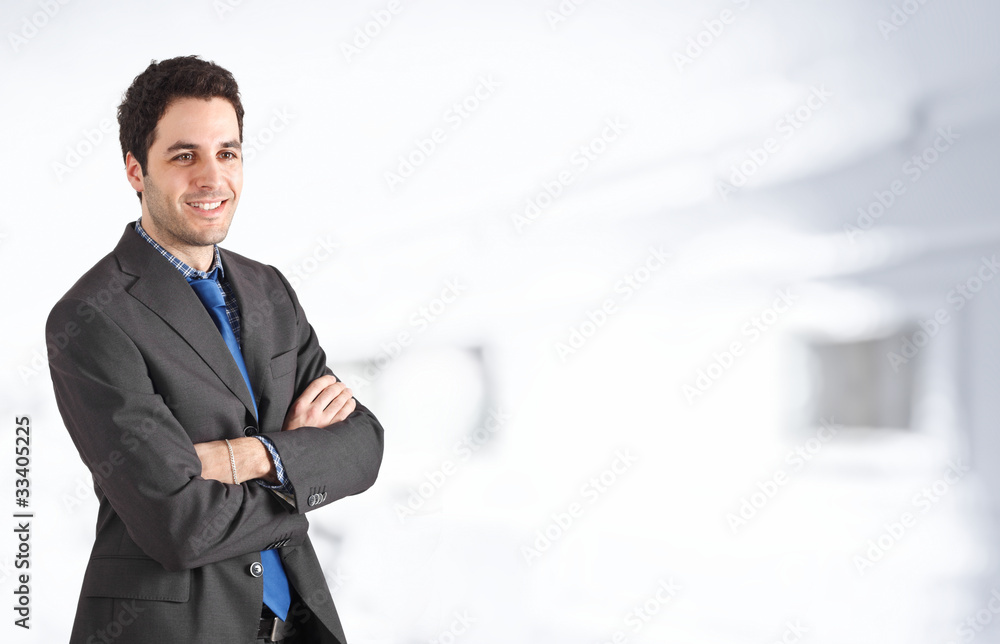 Young businessman smiling. Copyspace in the right side