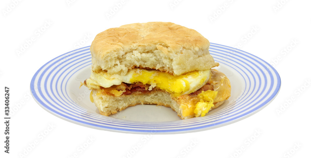 Bitten breakfast sandwich on blue plate