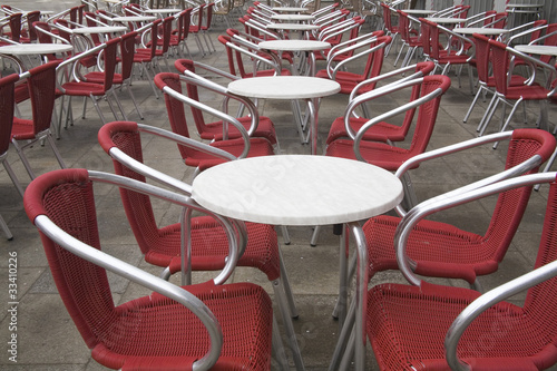 tables and chairs outdoor cafe in Piazza San Marco, Italy
